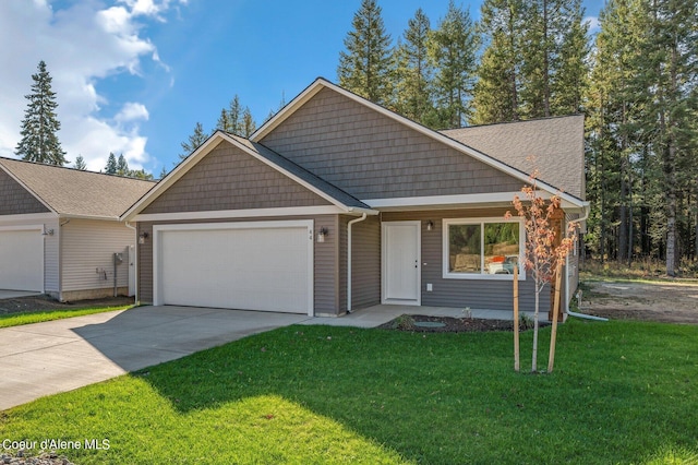 view of front of home with a garage, concrete driveway, and a front yard