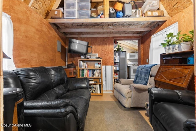 living room with wood walls and beam ceiling