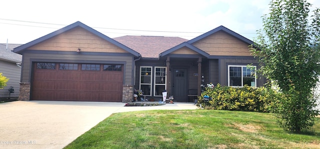 view of front facade featuring a garage, concrete driveway, stone siding, and a front yard