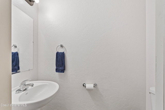 bathroom featuring sink and toilet