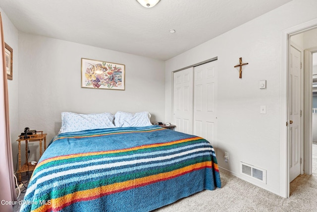 carpeted bedroom featuring a closet