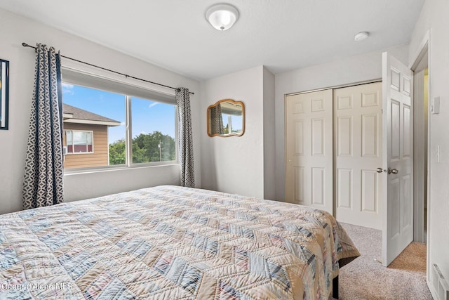 bedroom with carpet and a closet