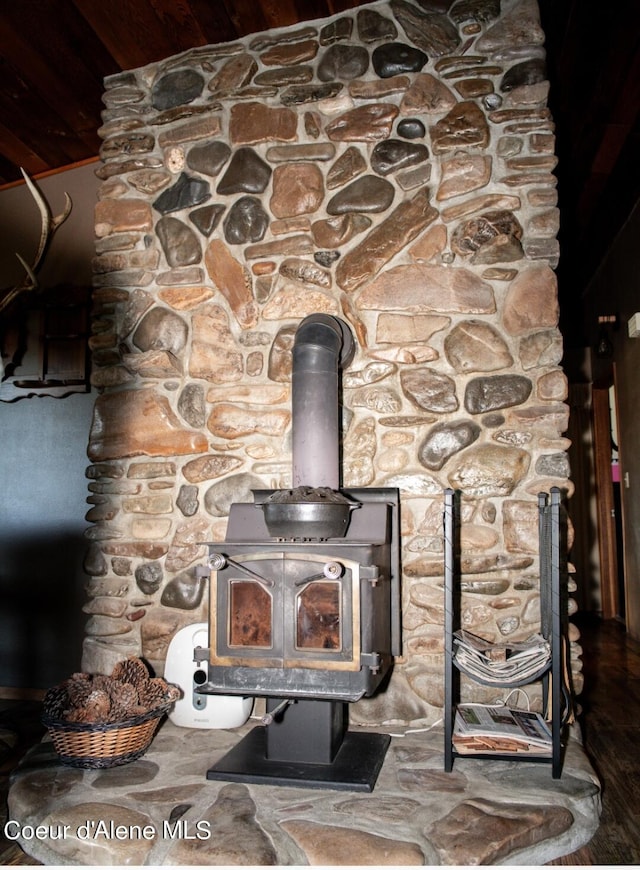 details with hardwood / wood-style floors and a wood stove