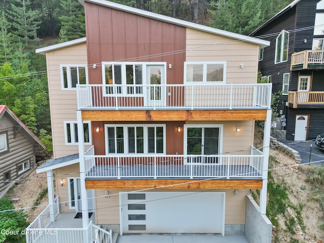 view of front of home featuring a garage and a balcony