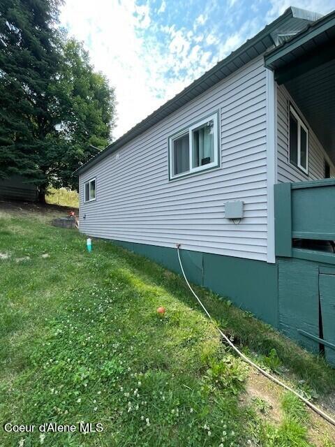 view of home's exterior with a yard