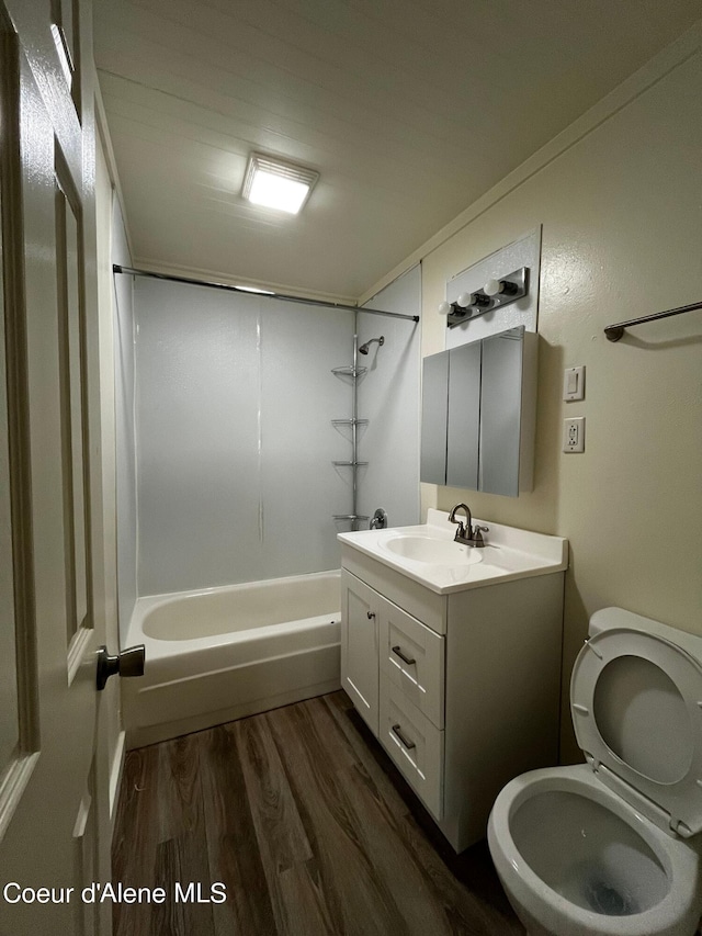 full bathroom with toilet, vanity,  shower combination, and wood-type flooring