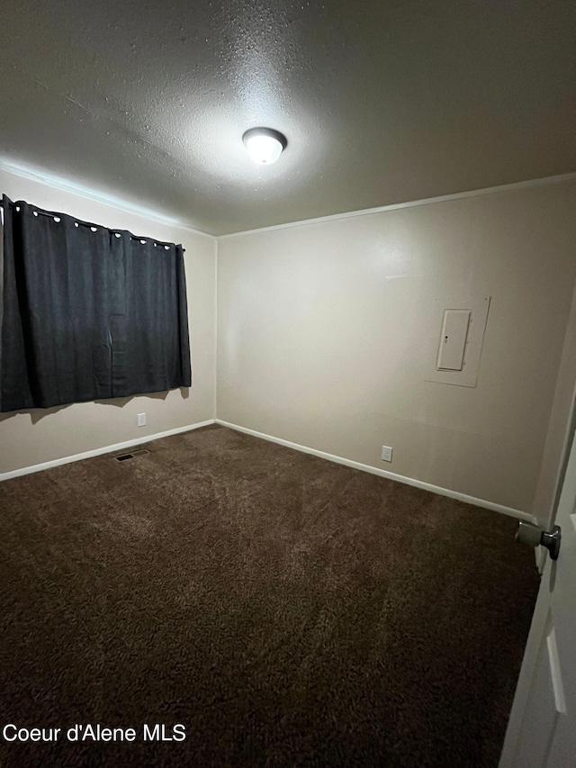 carpeted spare room featuring a textured ceiling