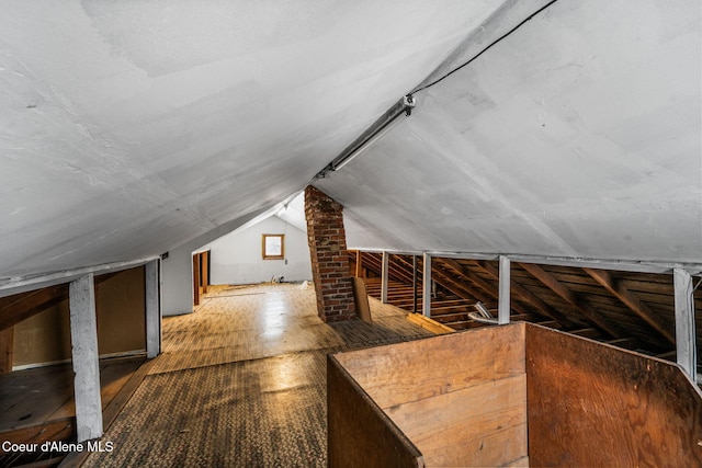 additional living space featuring lofted ceiling