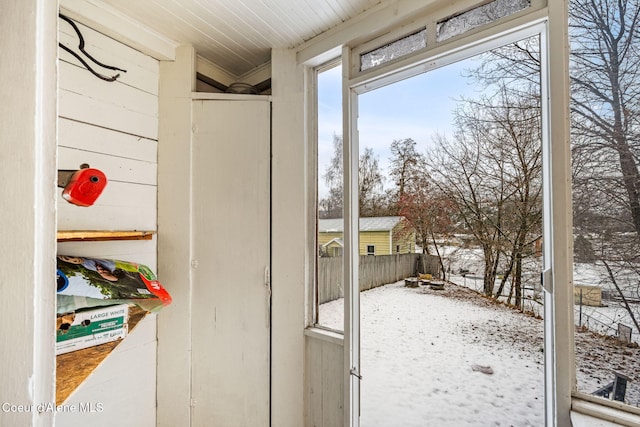 entryway featuring wooden walls