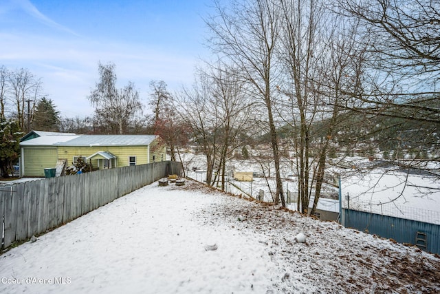 view of yard layered in snow