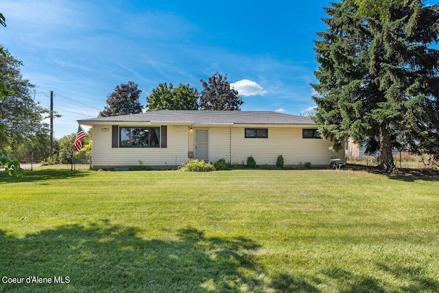 ranch-style home featuring a front yard and fence