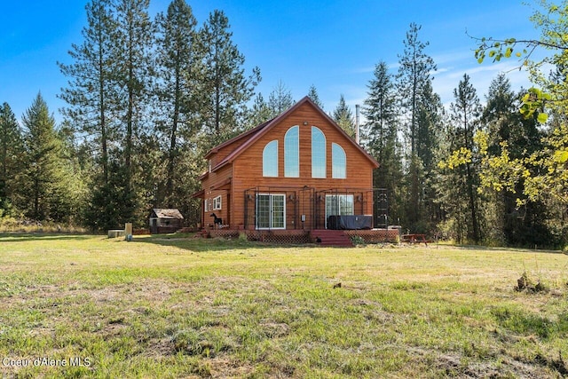 rear view of house with a lawn and a deck