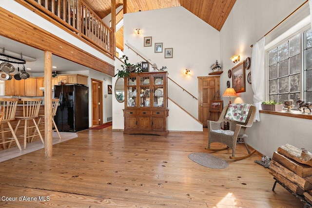 sitting room with stairway, wooden ceiling, high vaulted ceiling, and hardwood / wood-style flooring