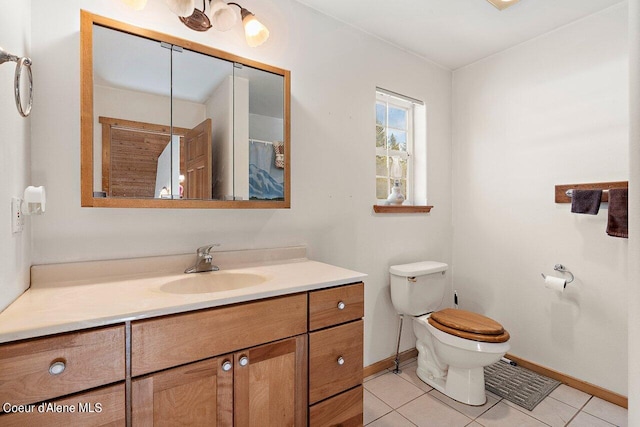 bathroom featuring tile patterned flooring, vanity, and toilet