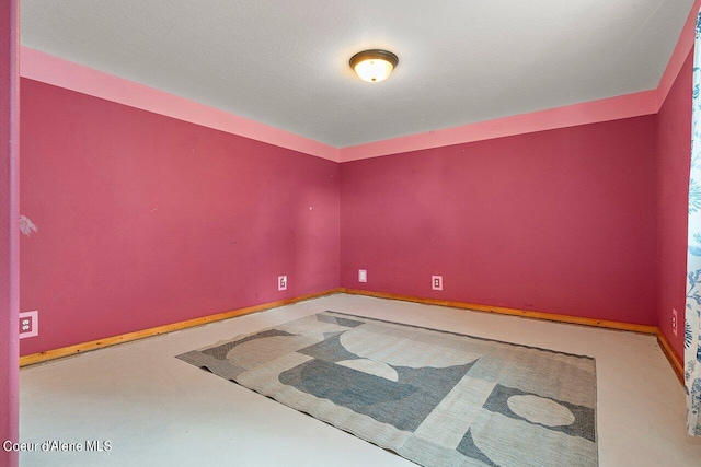 empty room featuring baseboards