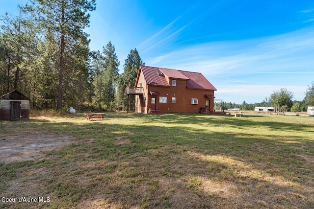 view of home's exterior featuring a yard and metal roof