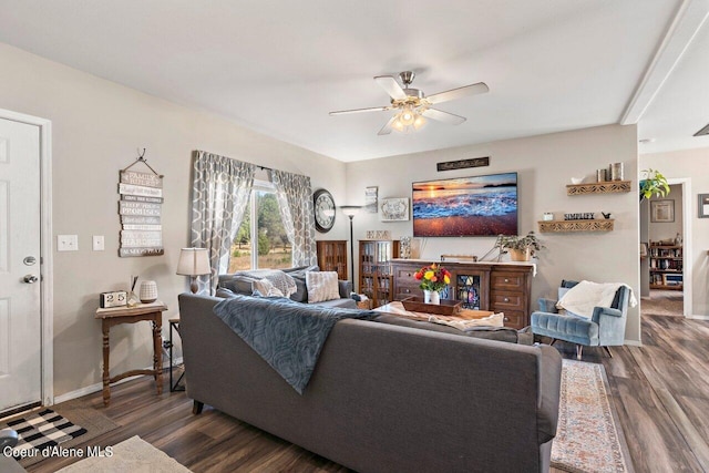 living room featuring baseboards, dark wood-style flooring, and a ceiling fan