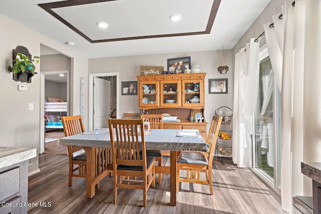 dining space with hardwood / wood-style flooring