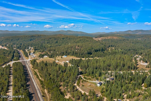 aerial view with a mountain view and a forest view