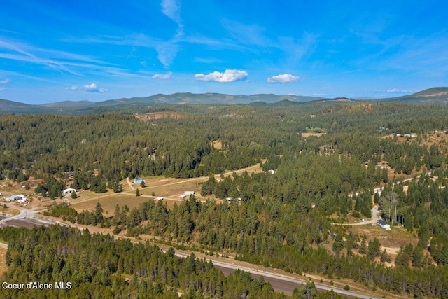 aerial view featuring a forest view and a mountain view