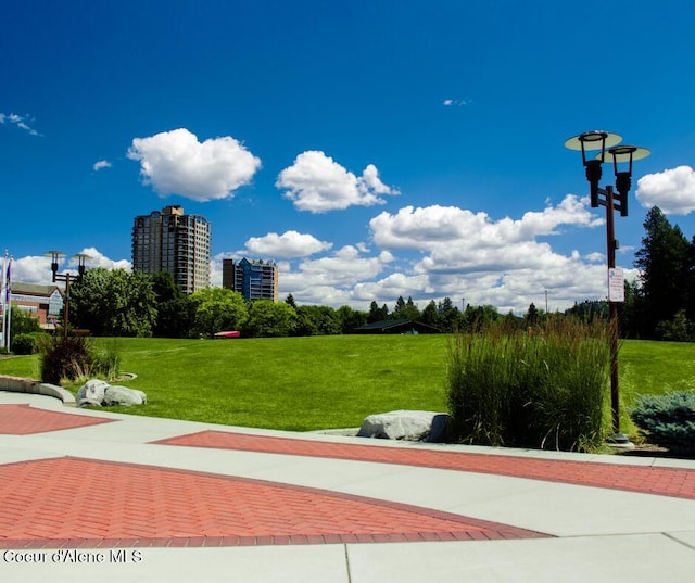 view of home's community with a lawn and a view of city