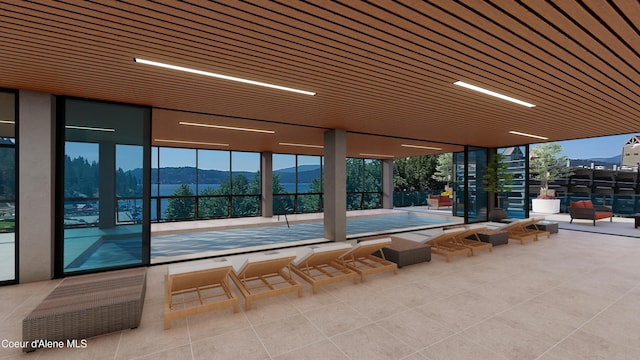 view of pool featuring a mountain view and a patio