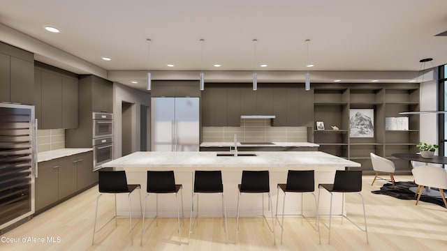 kitchen featuring gray cabinetry, stainless steel appliances, a kitchen bar, and modern cabinets