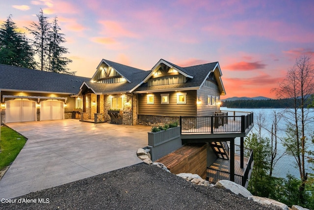 8491 N Mckinley Ln, Hayden, ID 83835 - view of front of house featuring stairs, stone siding, board and batten siding, driveway, and a garage