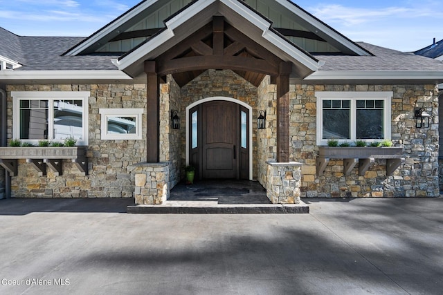 8491 N Mckinley Ln, Hayden, ID 83835 - entrance to property featuring stone siding, board and batten siding, and roof with shingles