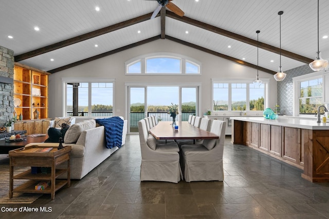 8491 N Mckinley Ln, Hayden, ID 83835 - dining area with beam ceiling, high vaulted ceiling, and stone tile floors