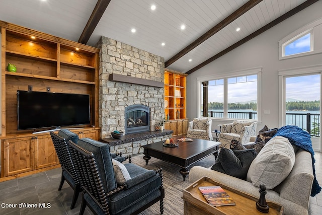 8491 N Mckinley Ln, Hayden, ID 83835 - living room featuring stone tile floors, recessed lighting, beam ceiling, a stone fireplace, and built in features