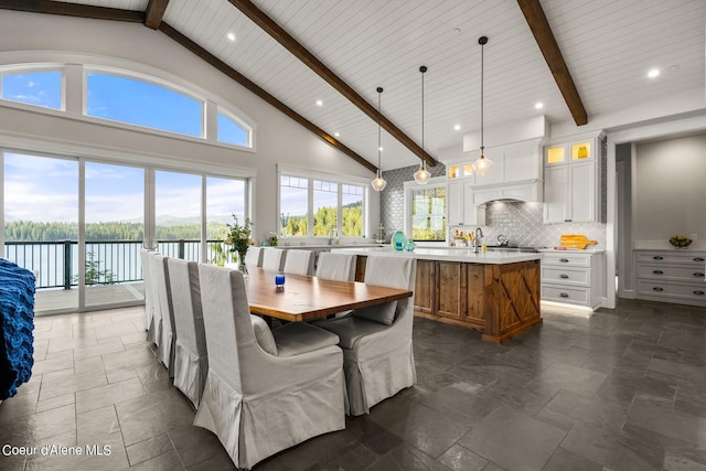 8491 N Mckinley Ln, Hayden, ID 83835 - dining space with high vaulted ceiling, stone tile floors, beam ceiling, and recessed lighting