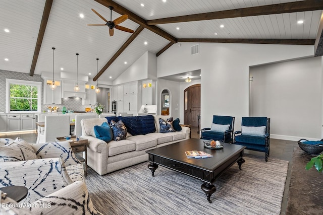 8491 N Mckinley Ln, Hayden, ID 83835 - living room with high vaulted ceiling, arched walkways, beam ceiling, visible vents, and a ceiling fan