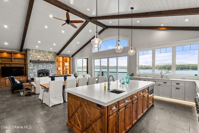 8491 N Mckinley Ln, Hayden, ID 83835 - kitchen with a center island with sink, a wealth of natural light, and stone tile floors