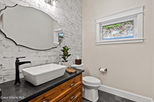 8491 N Mckinley Ln, Hayden, ID 83835 - bathroom with baseboards, toilet, and vanity