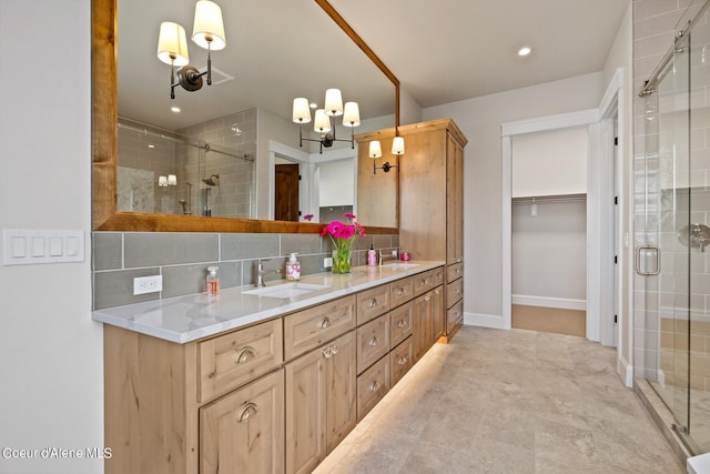 8491 N Mckinley Ln, Hayden, ID 83835 - bathroom featuring a stall shower, double vanity, tasteful backsplash, and a sink