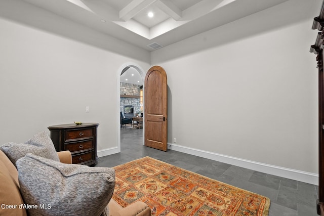 8491 N Mckinley Ln, Hayden, ID 83835 - living area featuring coffered ceiling, visible vents, baseboards, beamed ceiling, and arched walkways