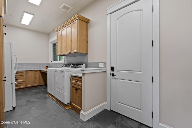 8491 N Mckinley Ln, Hayden, ID 83835 - laundry room with cabinet space, washer and dryer, and visible vents