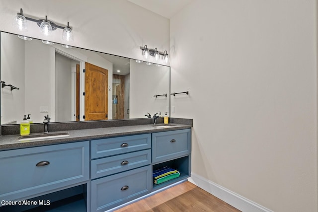 8491 N Mckinley Ln, Hayden, ID 83835 - full bathroom featuring double vanity, a sink, a shower stall, and wood finished floors