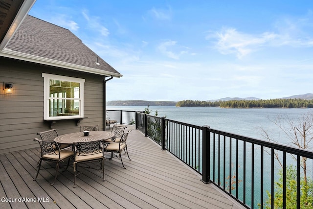 8491 N Mckinley Ln, Hayden, ID 83835 - wooden deck featuring outdoor dining space and a water view
