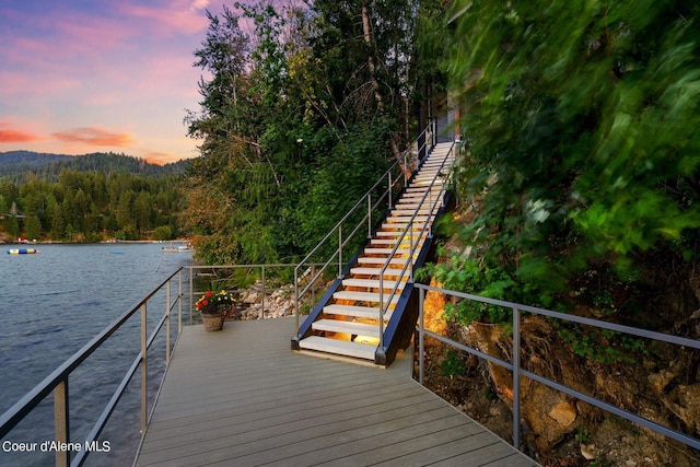 8491 N Mckinley Ln, Hayden, ID 83835 - view of dock featuring a water view, a view of trees, and stairs