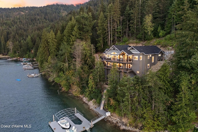 8491 N Mckinley Ln, Hayden, ID 83835 - aerial view at dusk with a water view and a view of trees