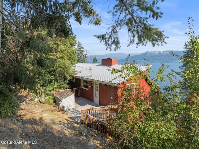 view of front of property featuring a deck with water view