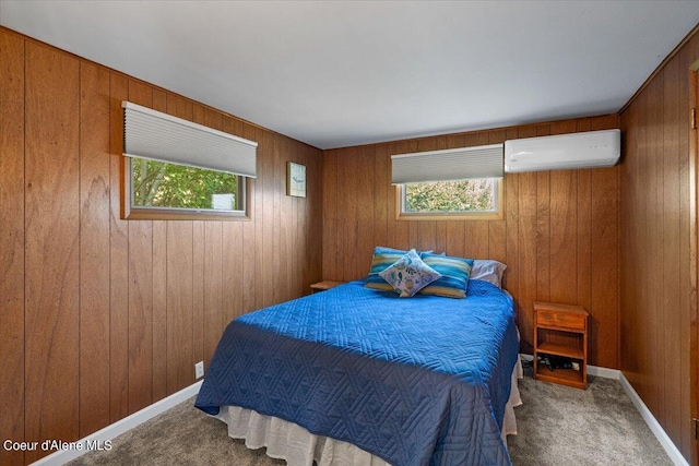 bedroom featuring carpet, wood walls, a wall unit AC, and baseboards