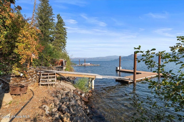 view of dock with a water and mountain view