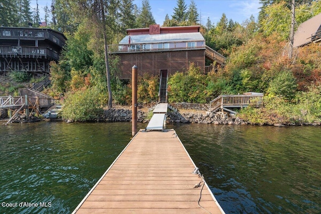 dock area with stairs and a water view