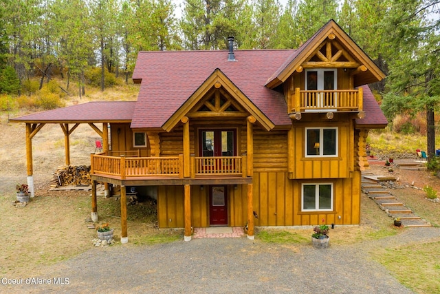 log-style house featuring a balcony