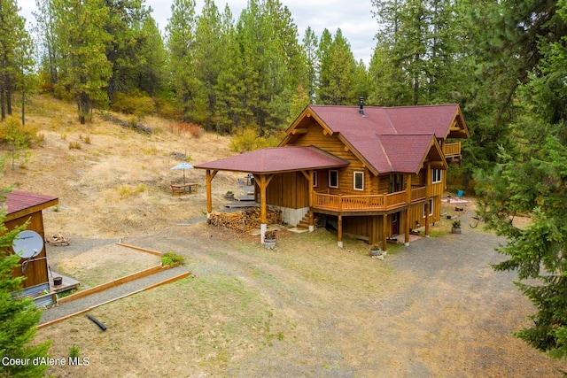 log cabin with a wooden deck