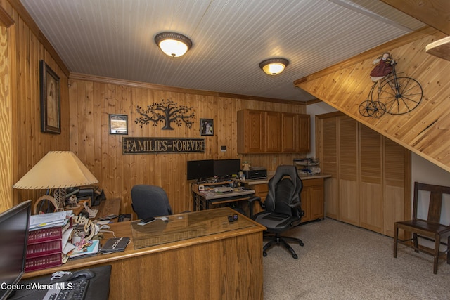 office area with ornamental molding, light carpet, and wooden walls