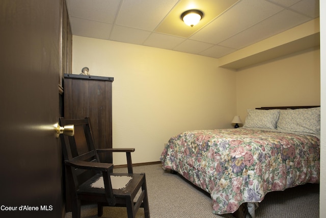 carpeted bedroom featuring a paneled ceiling